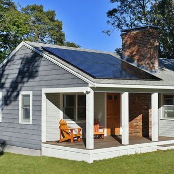 Small house with solar panels on roof