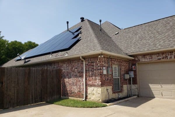 Range style brick house with solar panels on roof